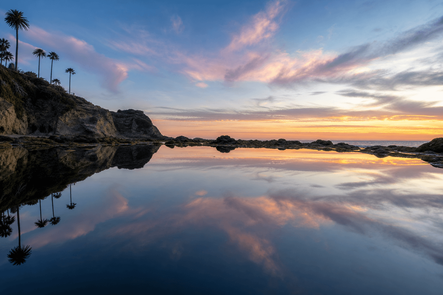 Perfectly still tidal pool reflecting the evening sky — duality and reflection representing identity work in BPD treatment